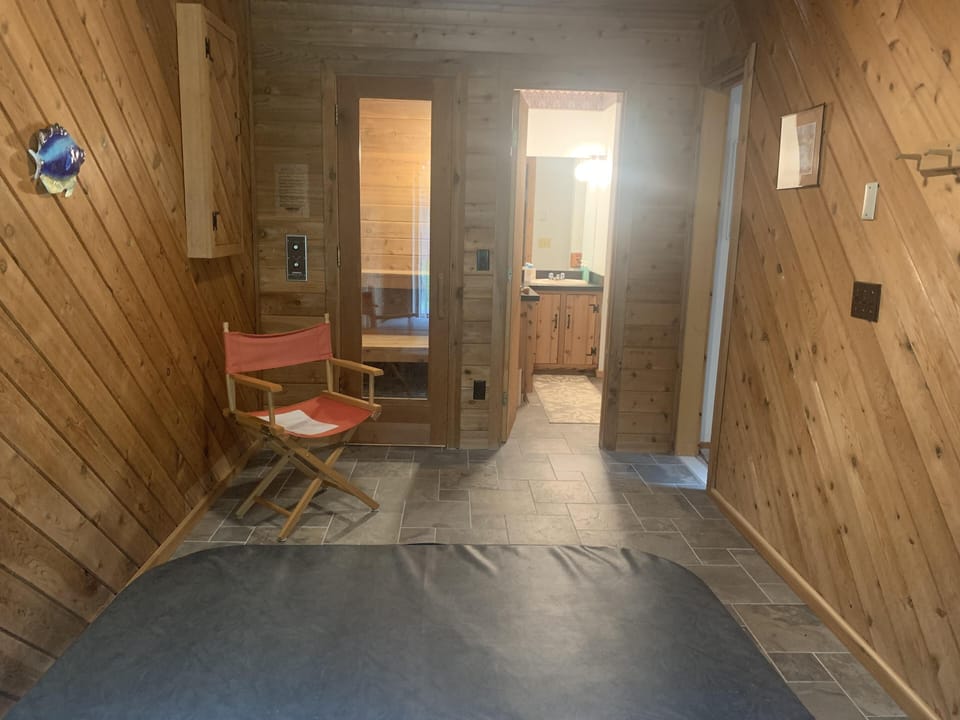 hot tub, sauna, and bathroom off of living room