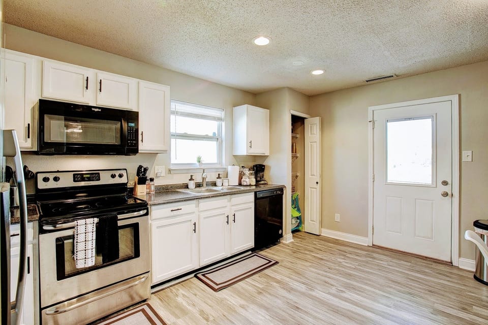 Full kitchen with exit to the back yard. 