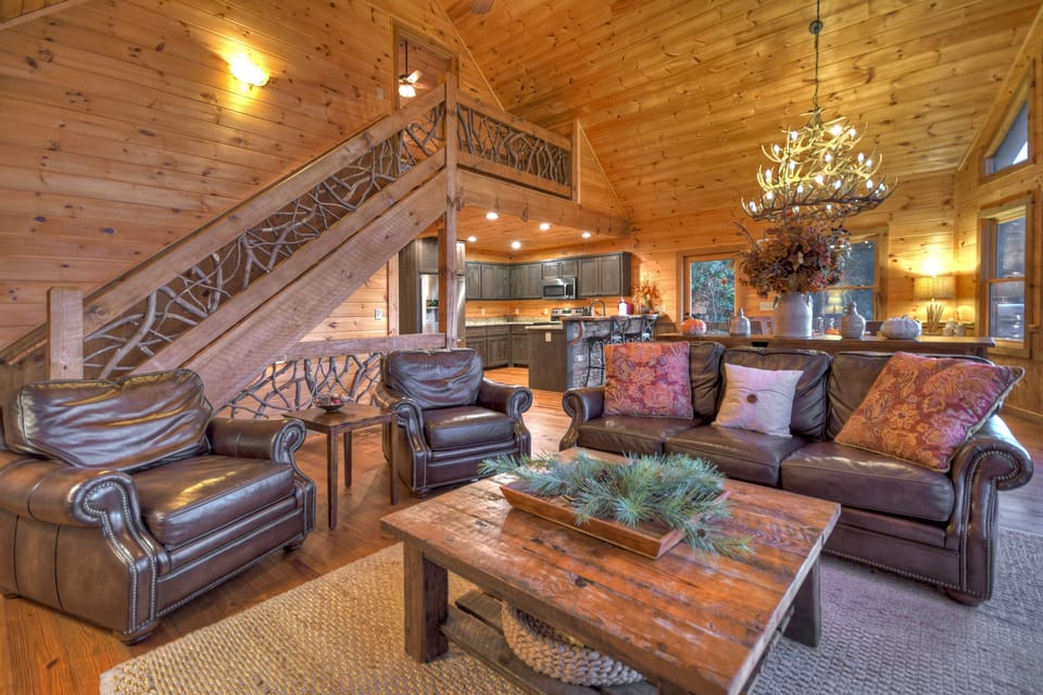 Spacious living area with leather seating and open kitchen.