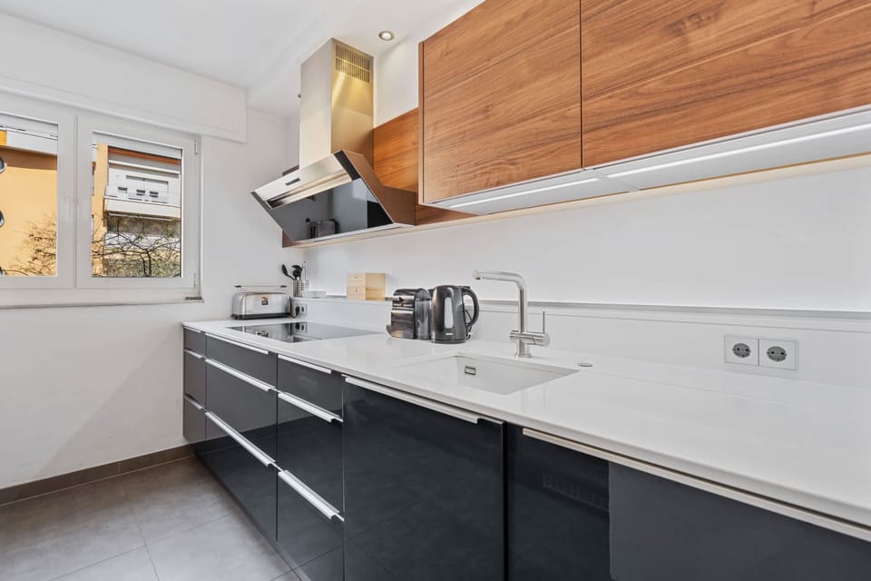 Cook with a view in our modern kitchen, featuring large windows for a serene urban outlook.