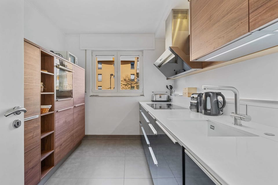 Prepare your meals with ease in this sleek, contemporary kitchen featuring high-end appliances, ample counter space, and plenty of storage. Perfect for long stays and culinary enthusiasts