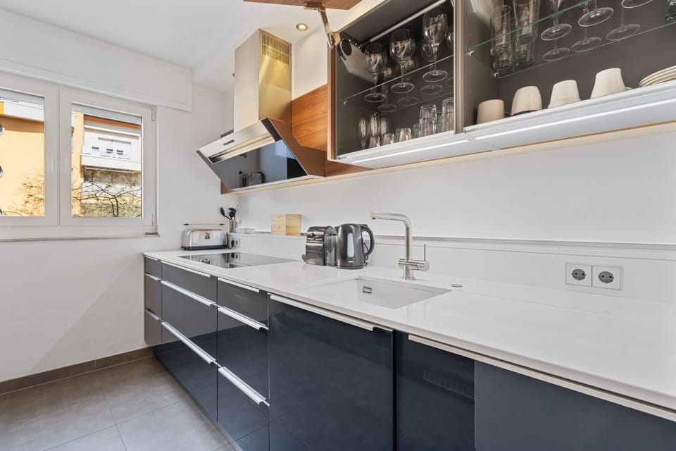 Our sophisticated kitchen offers a sleek design with integrated appliances and ample cupboard space.
