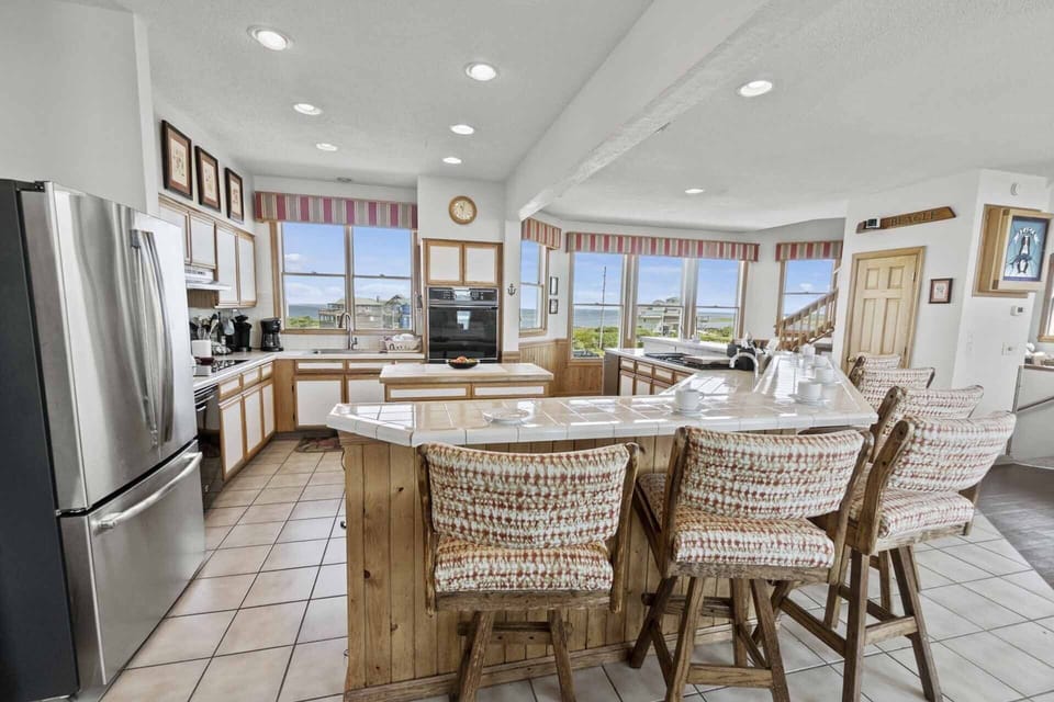 The well-stocked commercial kitchen is a chef’s dream, adept at accommodating large groups with an enormous refrigerator, 2 ovens, 2 dishwashers, and a large breakfast bar.