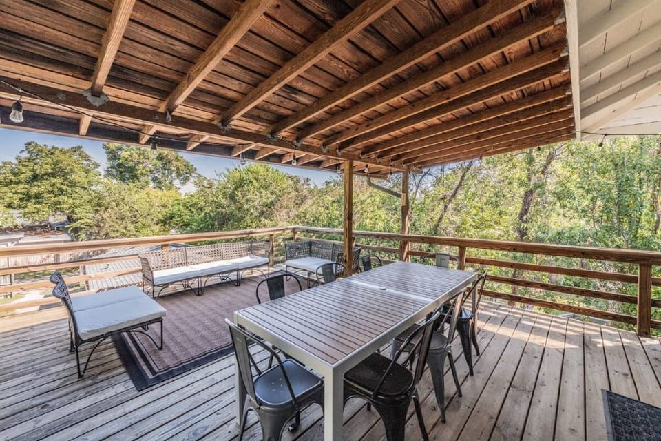 Outdoor partially covered deck with dining and lounge spaces