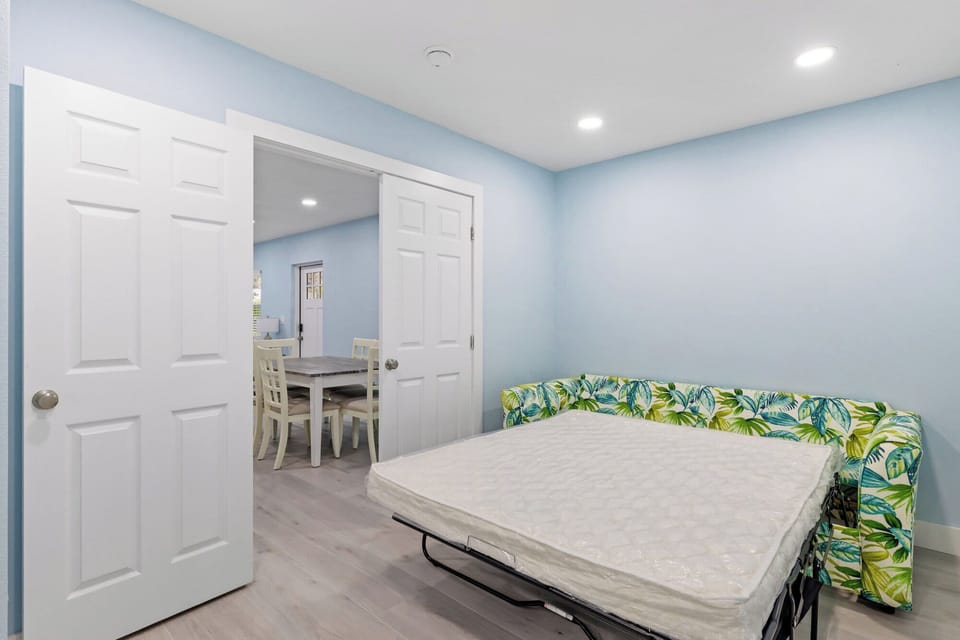 Memory foam queen sleeper sofa in opposite side of room with two twin beds