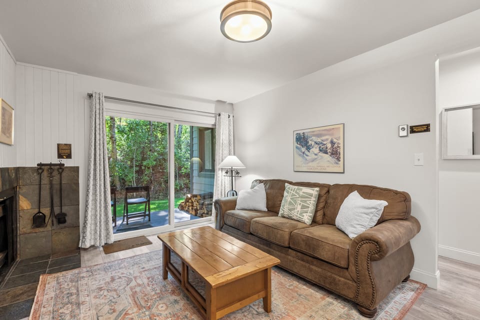 The living room offers a comfortable couch and sliding glass doors leading to a lovely patio.