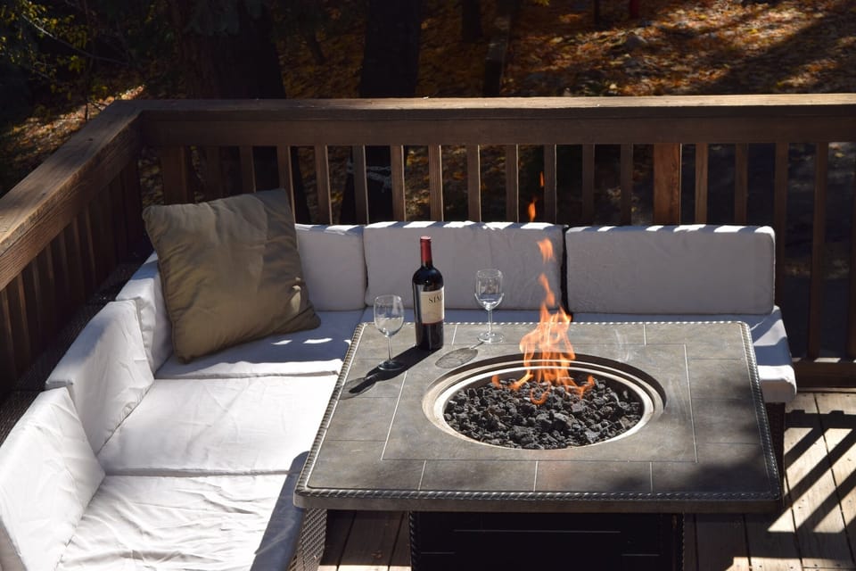Warm up to the fire table on the back deck with a glass of wine.