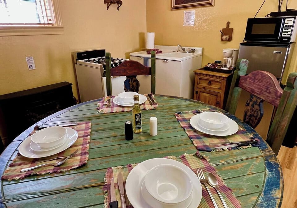Dining area and small kitchen stocked with cooking and eating amenities.   You just bring the food and do the cooking!