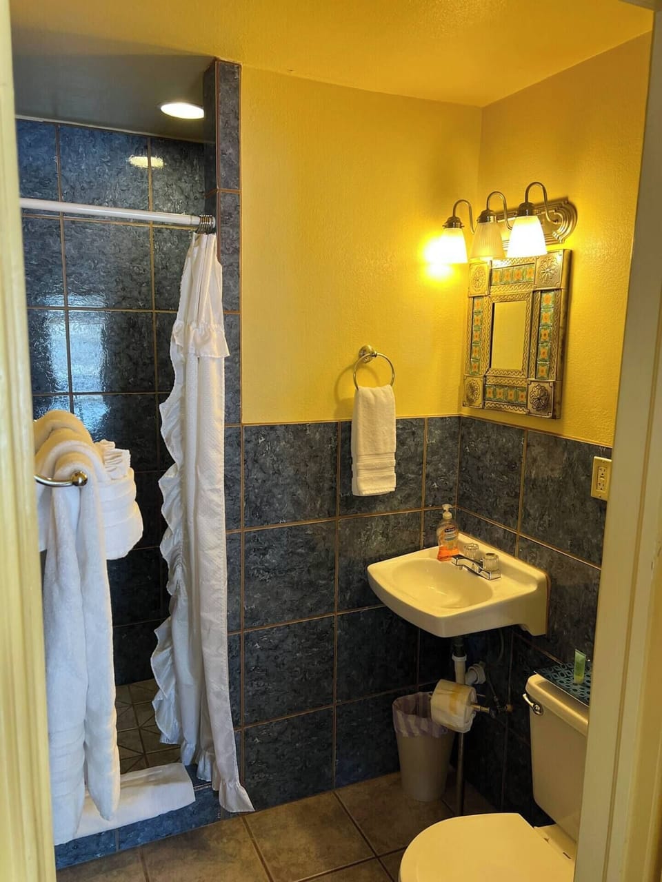Bathroom with walk-in tiled shower.