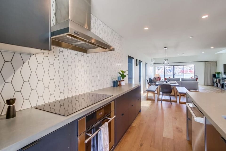 Located on the second floor, this kitchen boasts state-of-the-art appliances, custom cabinetry with soft close technology, waterfall counter top, 4 bar top seats, split system AC, and a southeast facing balcony.