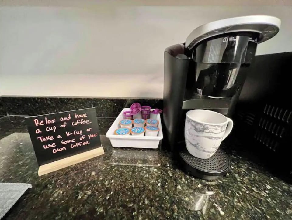 Coffee station with provided K-Cups, reusable pods, sugar and creamer.