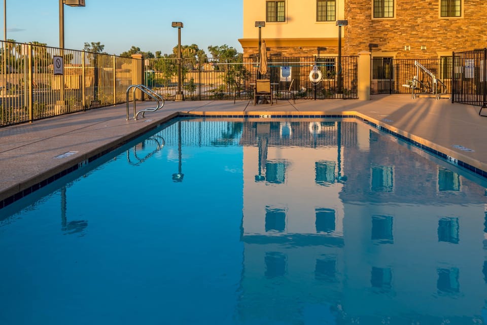 Outdoor pool with clear blue water and surrounding deck.