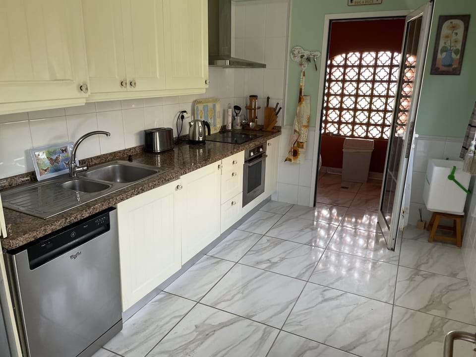 Spacious kitchen with utility room off it with automatic dishwasher.