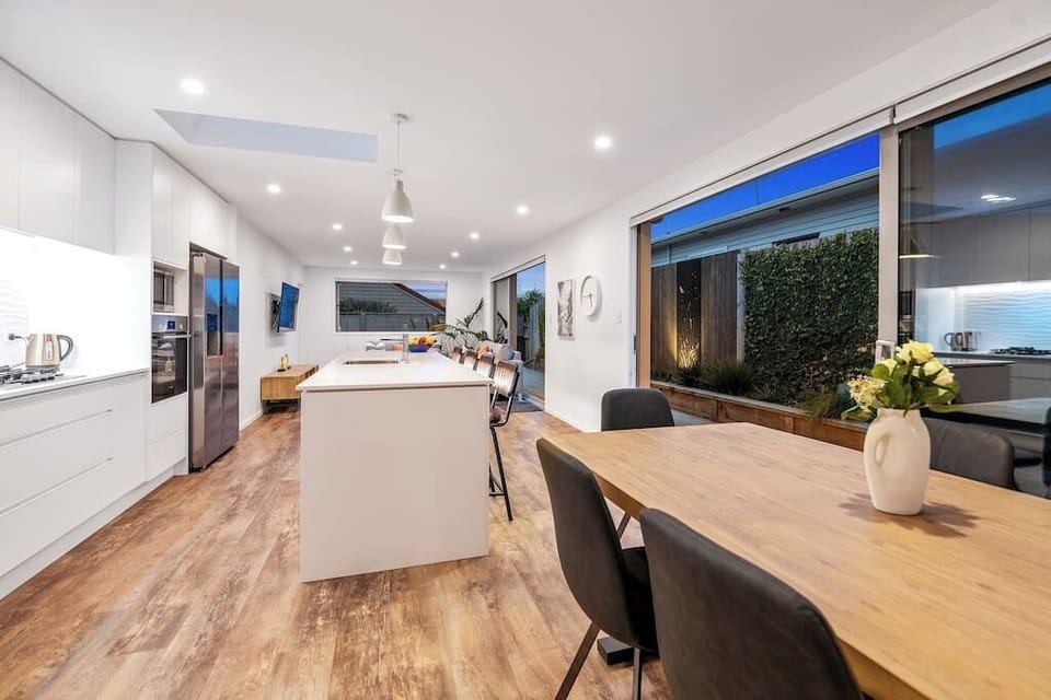 Open plan dining/kitchen and living area with sliding doors on to the deck.