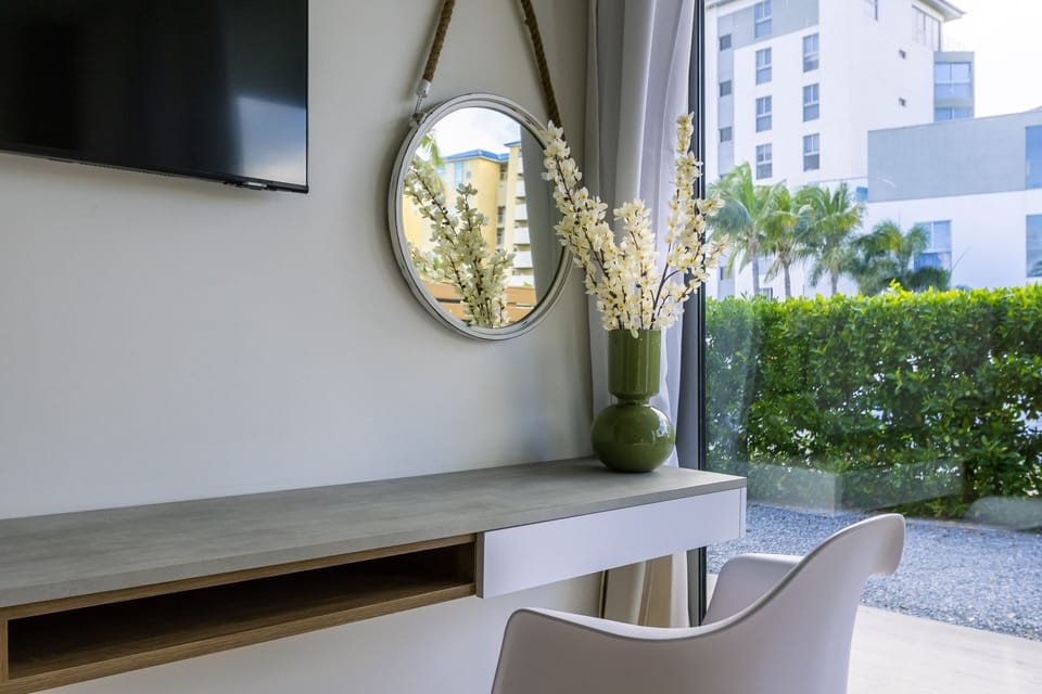 Relax in your modern space with city views—natural light, elegant furnishings, and peaceful greenery just outside create a calm, inviting retreat after exploring.