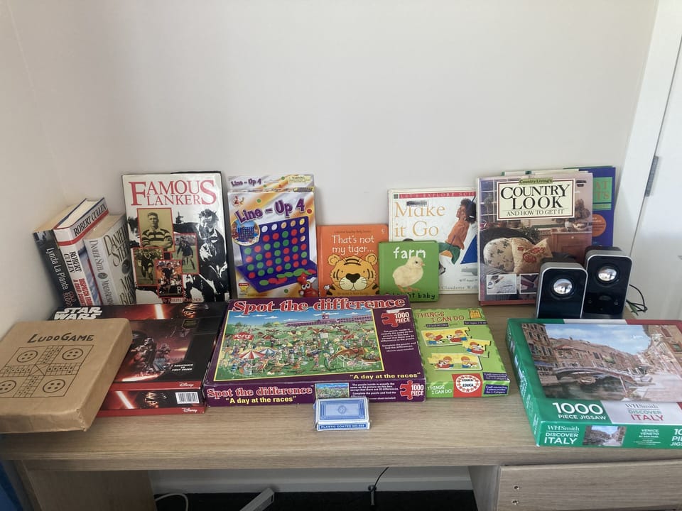 An array of books, children and adult games and jigsaws 