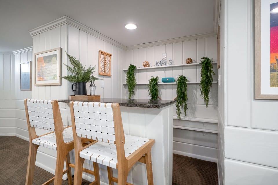 Your stylish kitchen island creates the perfect spot for morning coffee or casual meals with its elegant stools and cascading greenery.