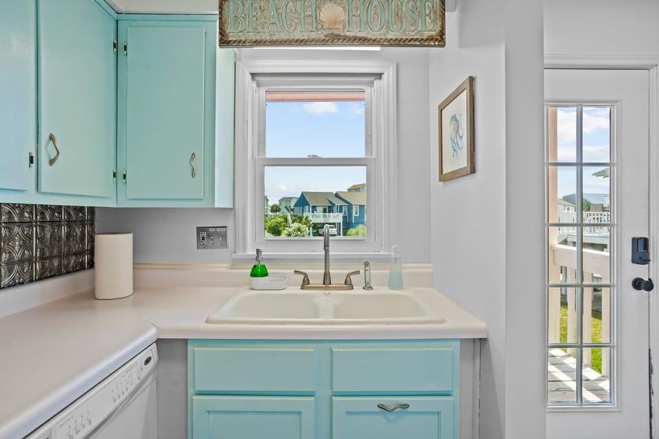 Dish soap, hand soap, paper towels, and other cleaning supplies are provided.