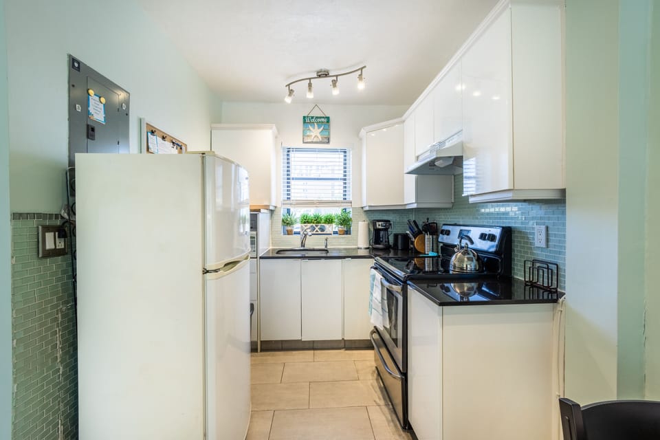 Kitchen has full size refrigerator, stove and oven, and basic cooking utensils.