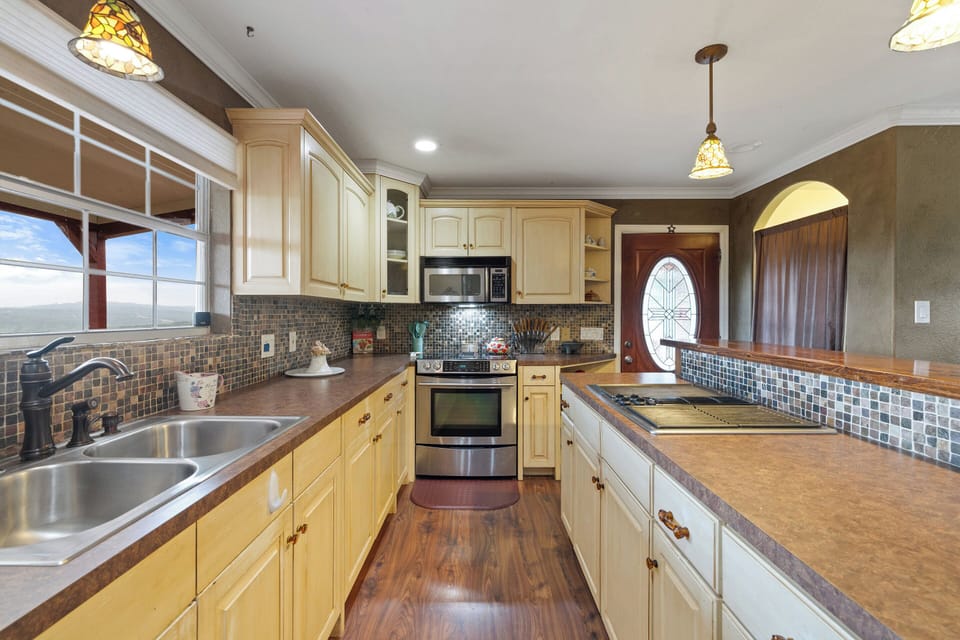 kitchen range barbeque grill with large scenic hillview window