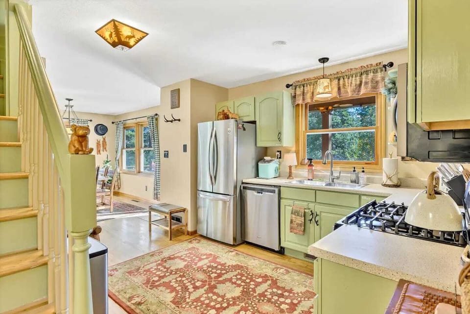 The kitchen provides modern comforts like stainless steel appliances, while still keeping a cozy atmosphere.
