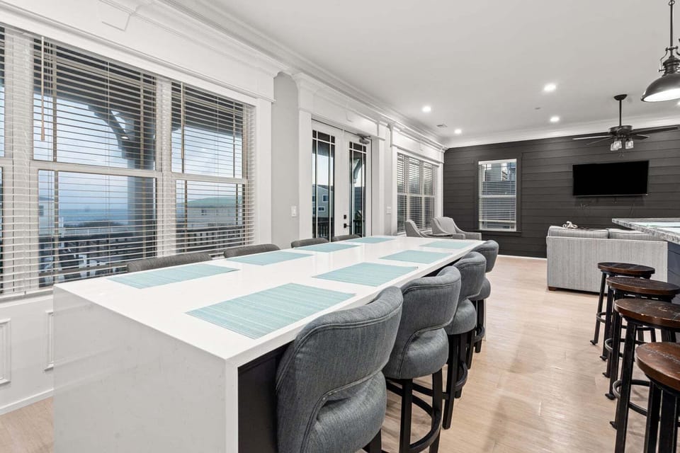 Bar counter seating beside sliding doors at Oceanside Charm, a 6-bedroom Cherry Grove vacation rental