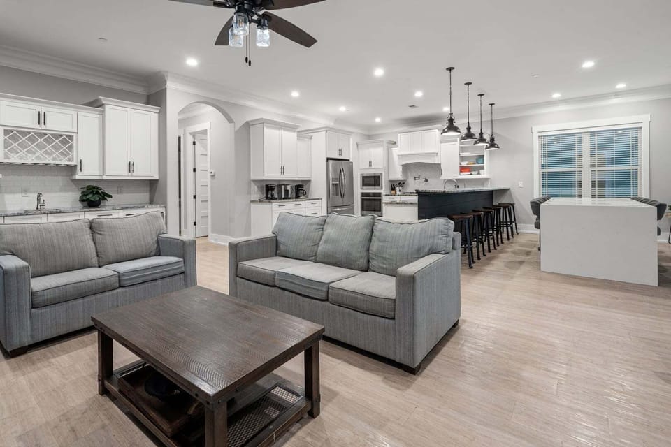Gathering space with a kitchen island and bar stools at Oceanside Charm in Cherry Grove, North Myrtle Beach