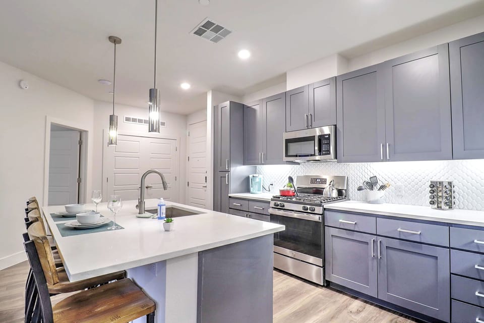 Whip up meals in the modern kitchen, fully stocked with appliances, cookware, and essentials for everyday cooking.