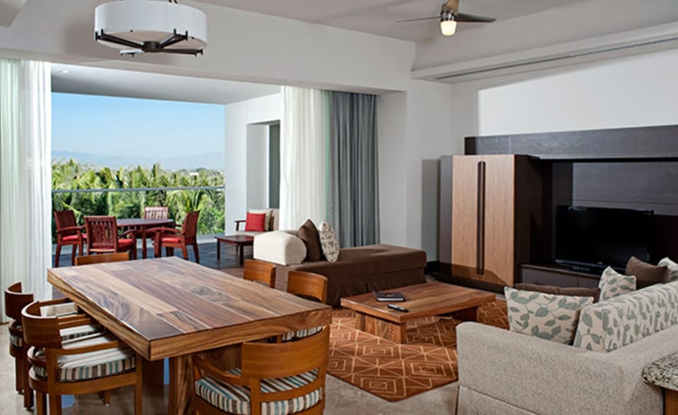 Family room with dining table and 4 chairs.  Smart TV and fireplace. 