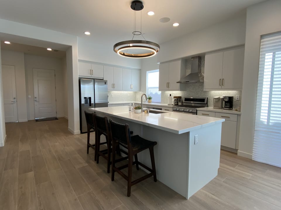 Kitchen with large island stainless appliances and cooking essentials