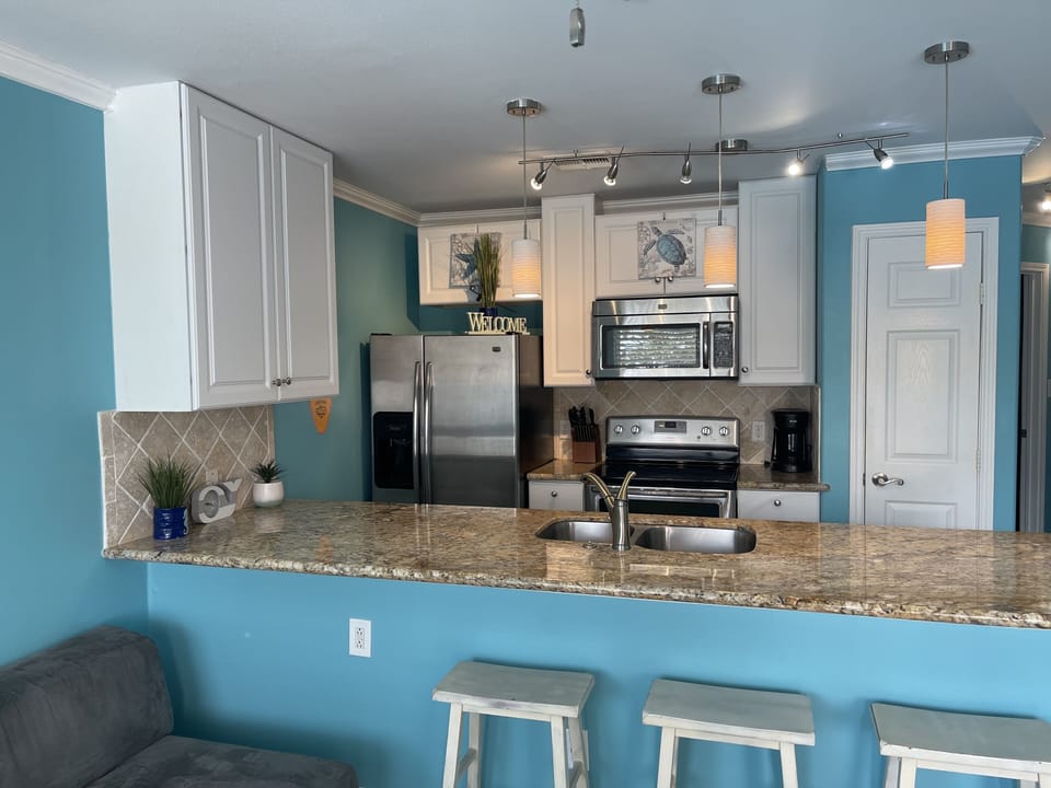 Full size kitchen with barstools. 
