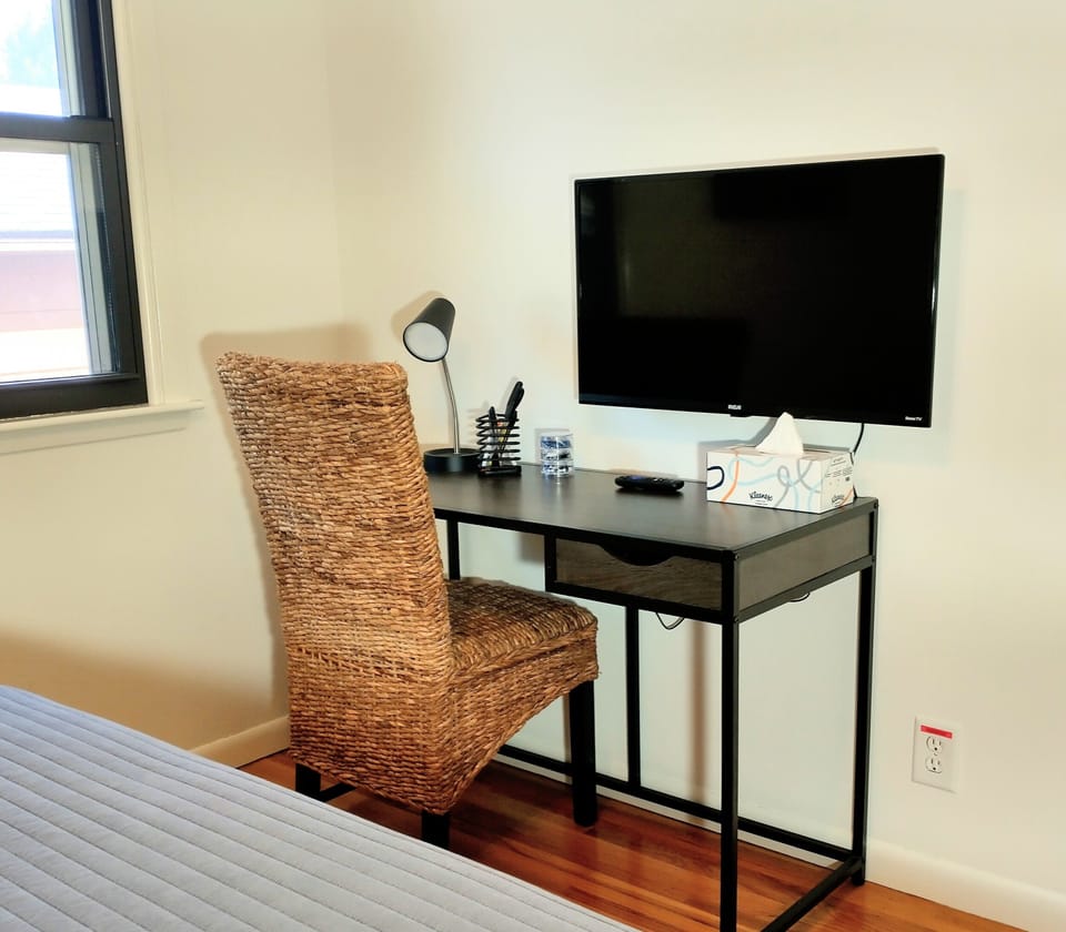 Bedroom 2: Office area with supplies and Roku TV 