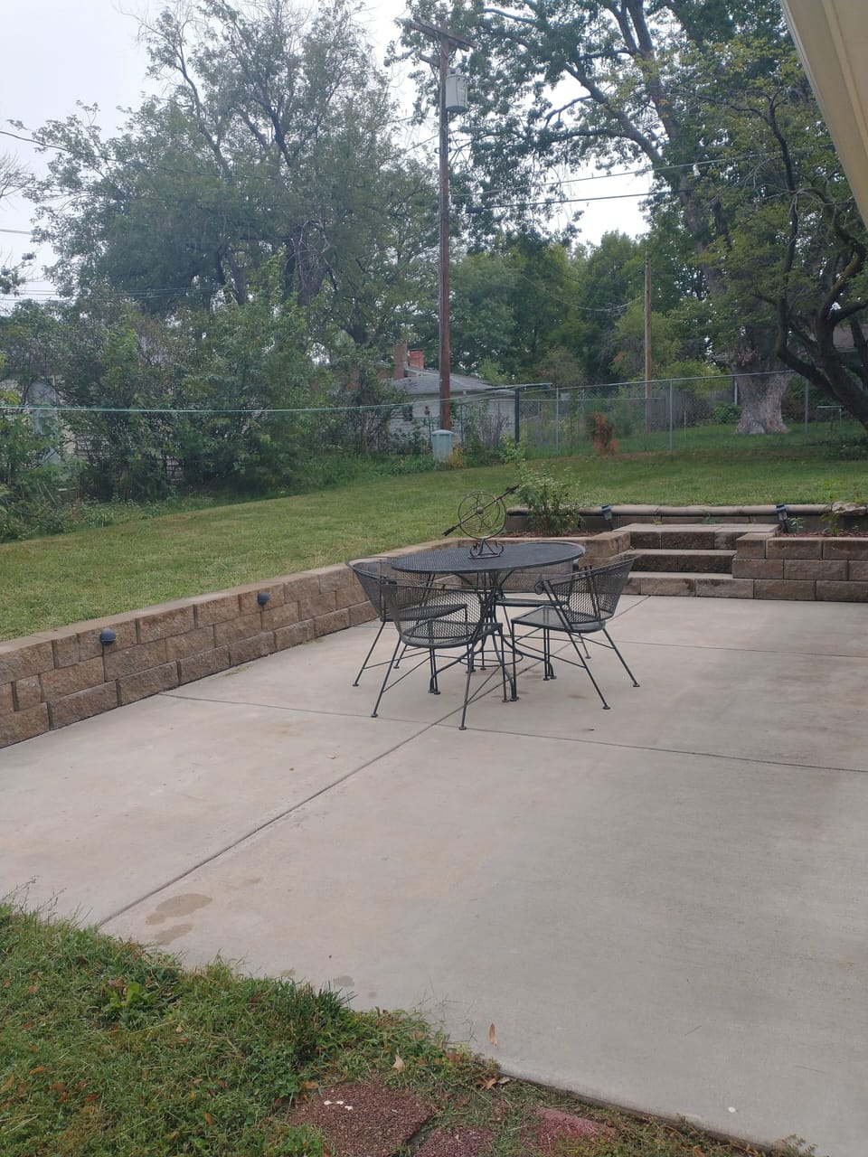 Patio and furniture for outdoor dining; back yard 