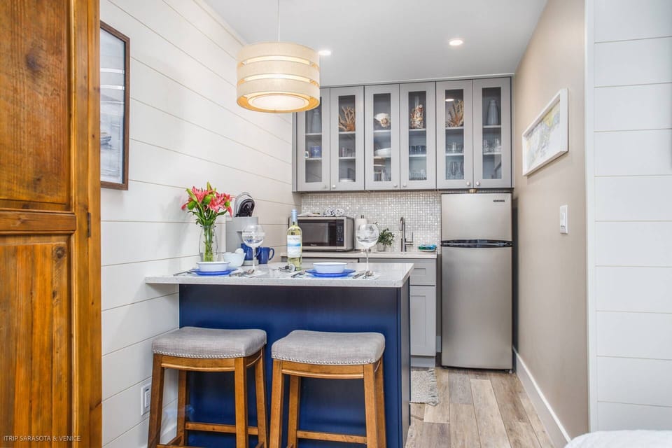 Seating for two at the gorgeous kitchen counter.  Kitchen stocked with dishes, glasses, utensils & more.