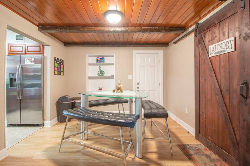 Dining room, refrigerator, wall shelf with wall decoration, access door