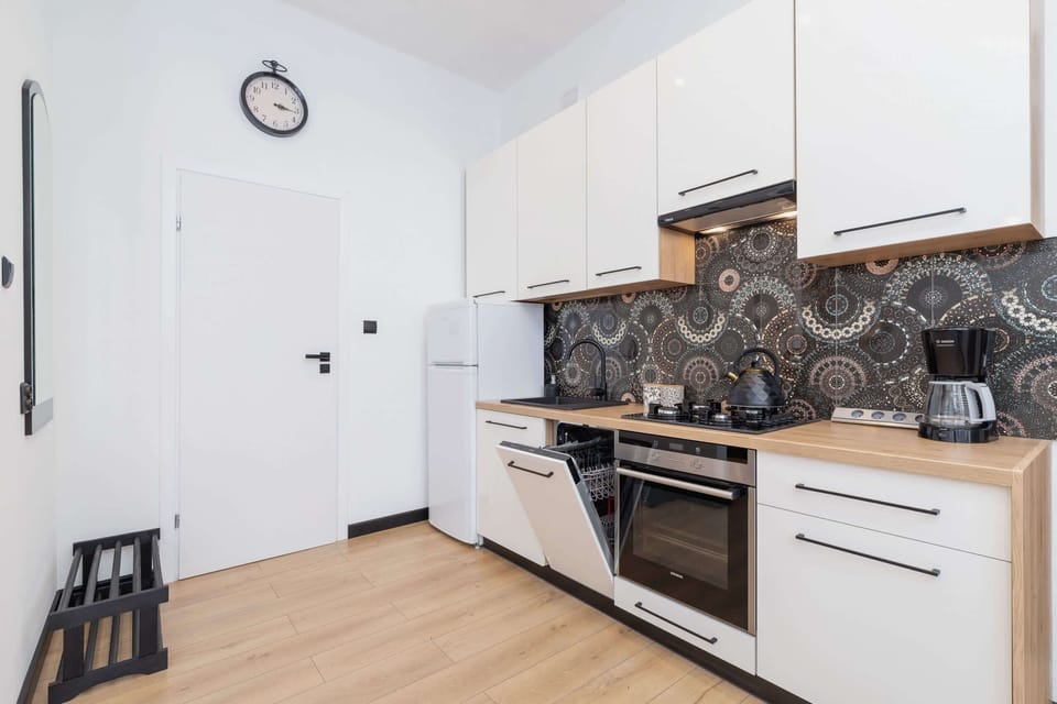 Another angle of the kitchen area, showcasing the clean, modern appliances and loft structure.
