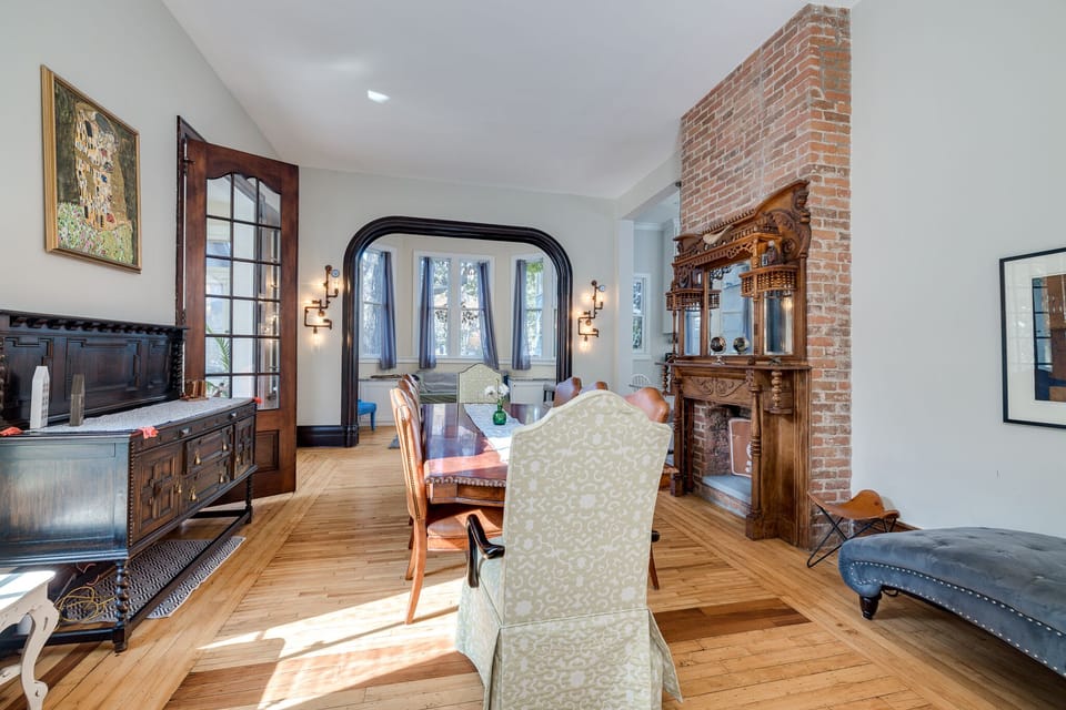 Large Dining room with ornate wood floors and fireplace, lots of seating options
