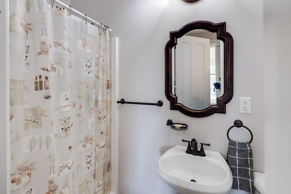 Bathroom two is a full bathroom with shower on main floor, ensuite to movie room