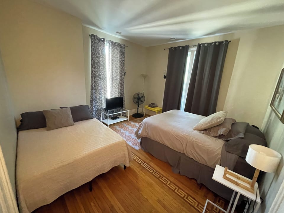 2nd floor bedroom with two queen beds, TV, Huge windows and beautiful floors!