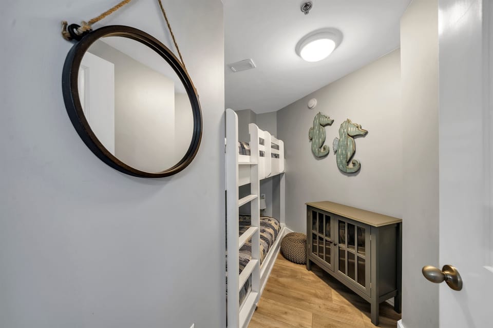 Bunk room with door with twin size beds