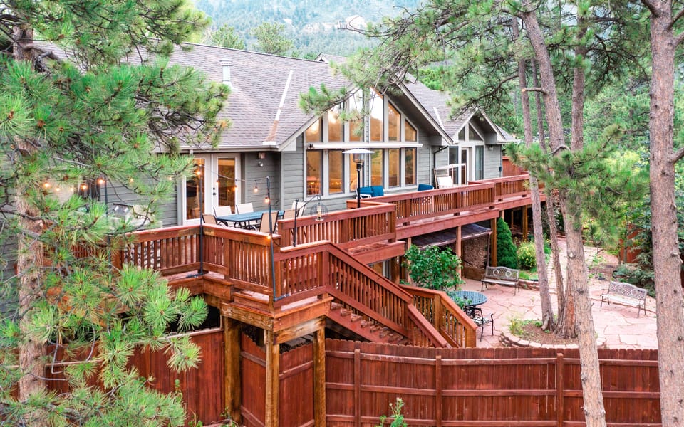 The Bird House is surrounded by pine trees with Pike Peaks view