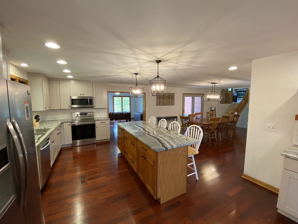 Kitchen and Dining room, with game room in the background.
