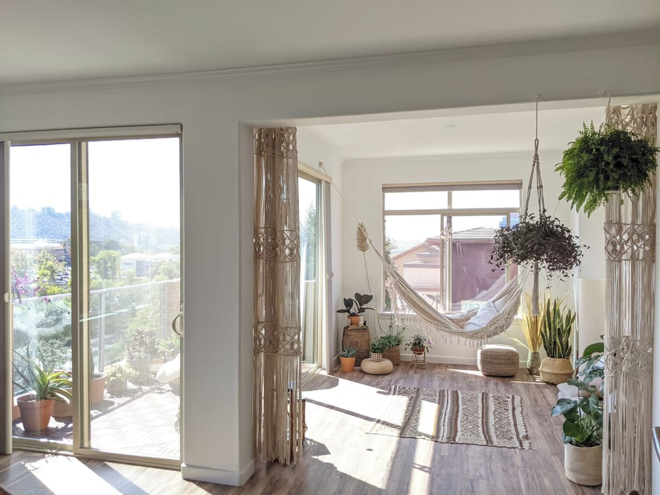 Your Zen den: hammock, floor cushions, and upright piano for relaxation.