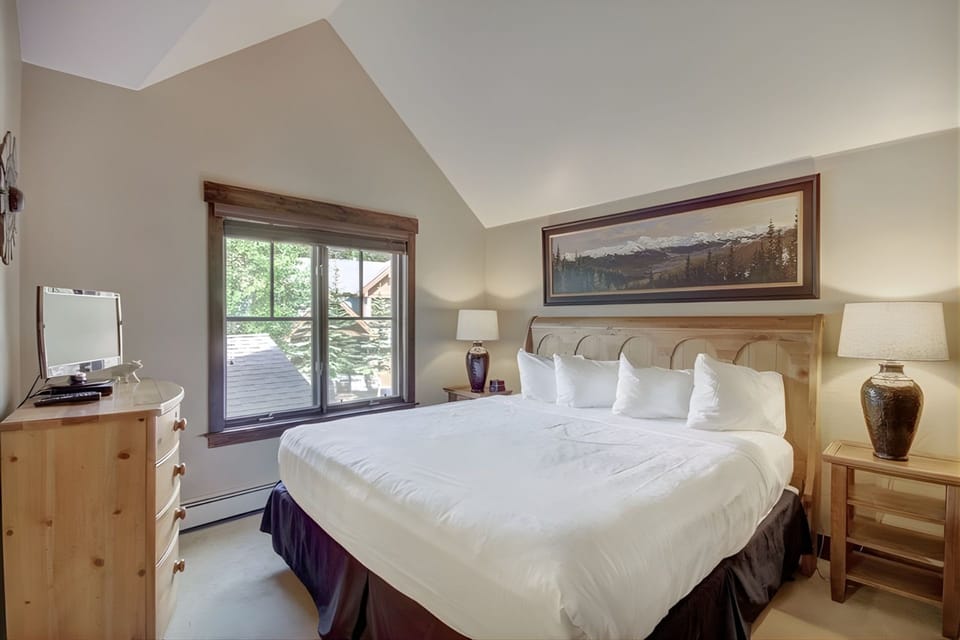 Retreat to this tranquil bedroom, where soft linens and natural light promise restful slumber—bedding configurations vary by unit.