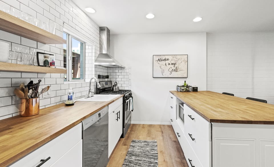 Stainless steel appliances with microwave on the peninsula. 