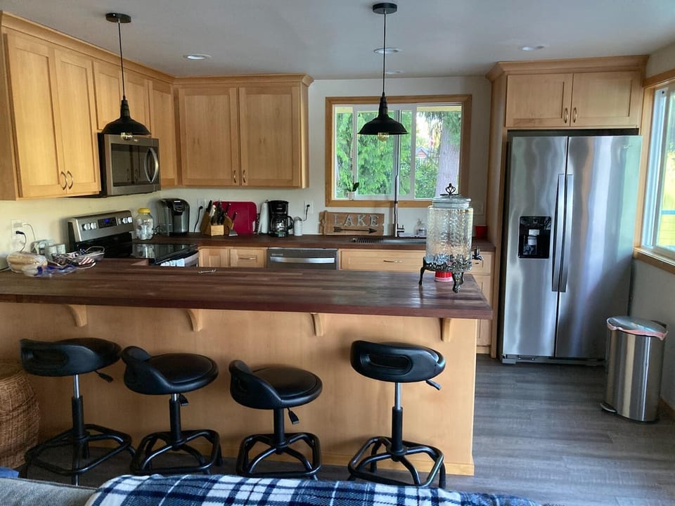 The large, full kitchen seats four and has dishwasher, refrigerator & microwave.