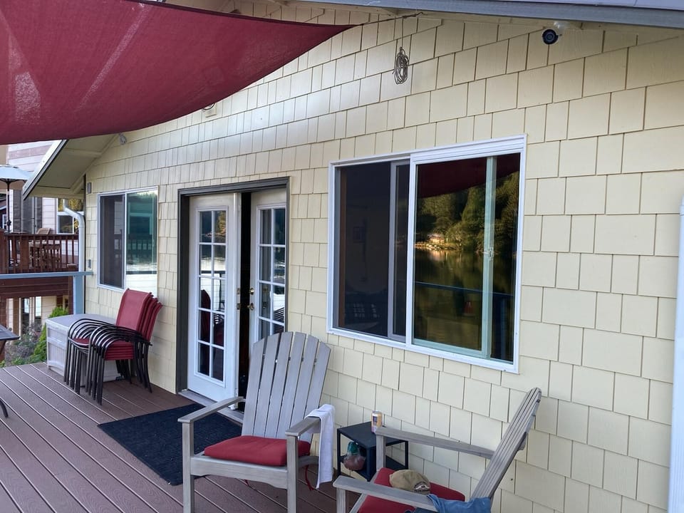Front of the main cabin with shingle siding, French doors that open up WIDE.
