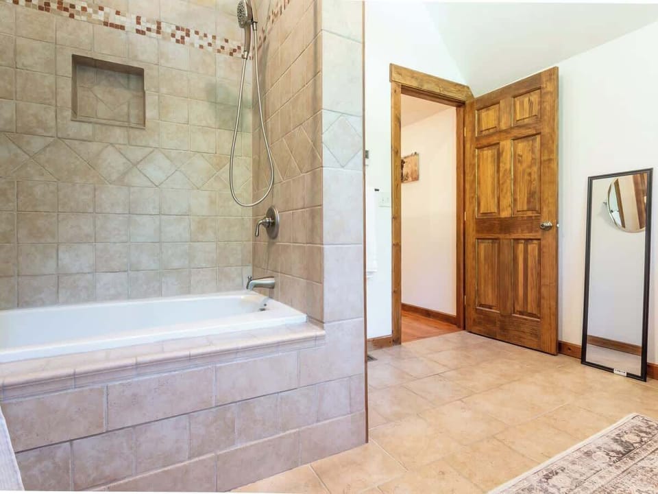 Full bathroom on the second floor with a large soaking tub and huge double vanity, perfect for storing toiletries.