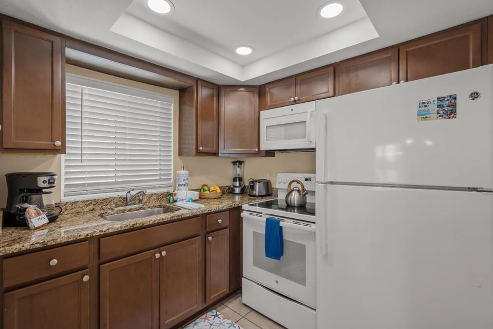 Kickstart your day—compact yet complete kitchenette with stove, microwave, and counter seating for two. Bay views add a special touch.