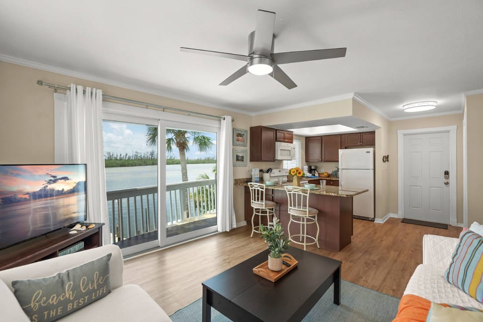 Bright, breezy and bayfront – Relax in the living room with sunshine and water views.